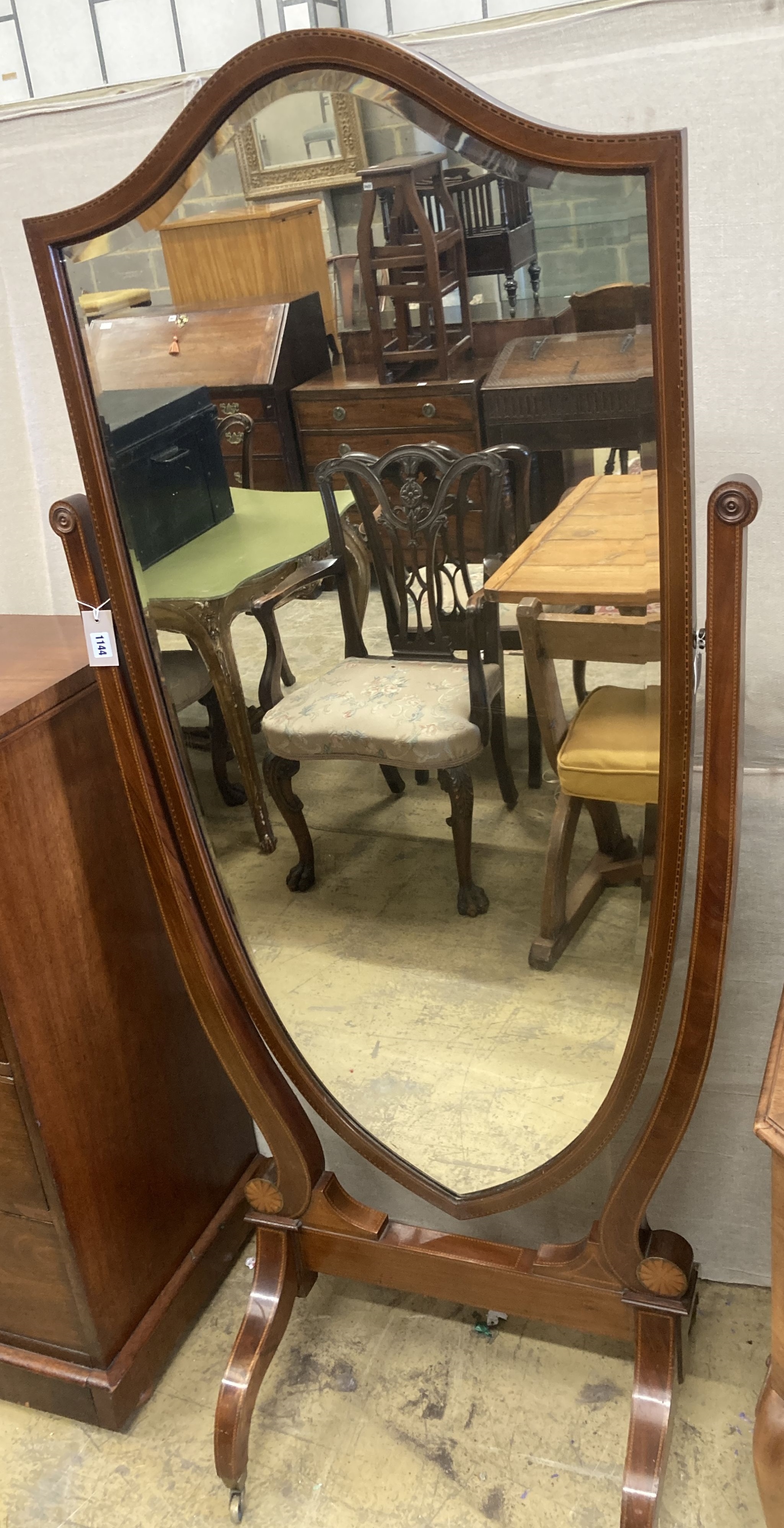 A large Edwardian inlaid mahogany shield shaped cheval mirror, width 80cm, height 177cm